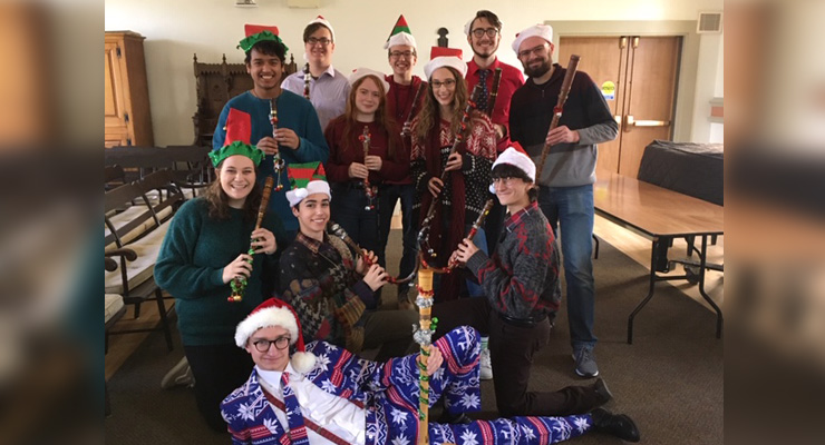 teaching-krummhorns-2 Teaching krummhorns class, who are dressed in Santa and elf hats